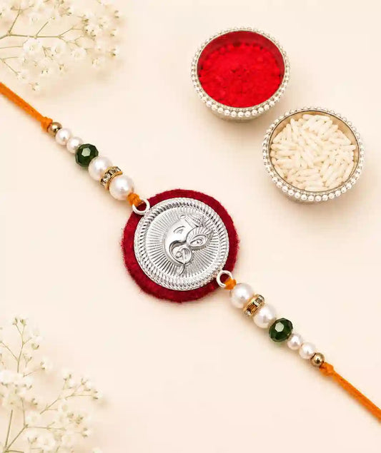 Ganesha rakhi with green & white pearl  