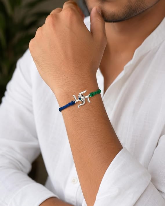 99.5% Pure Silver Swastik Ganesha Rakhi with blue and green braided thread by Madhaviya Jewels for Raksha Bandhan gift