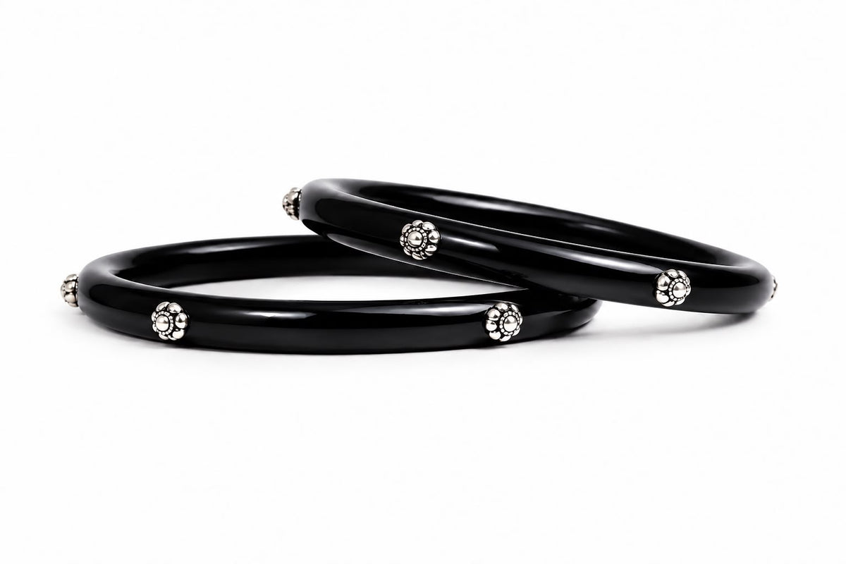Glossy black bangles with silver floral embellishments