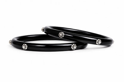 Glossy black bangles with silver floral embellishments
