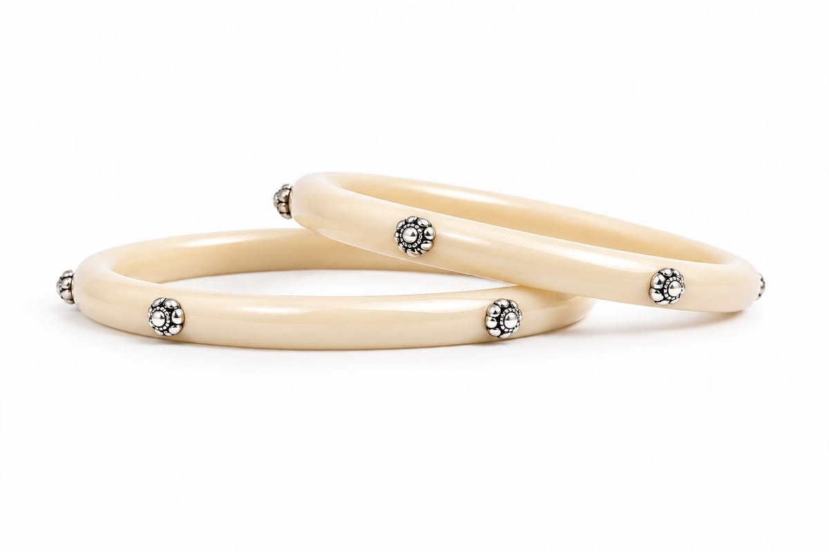 Glossy cream bangles with silver floral embellishments