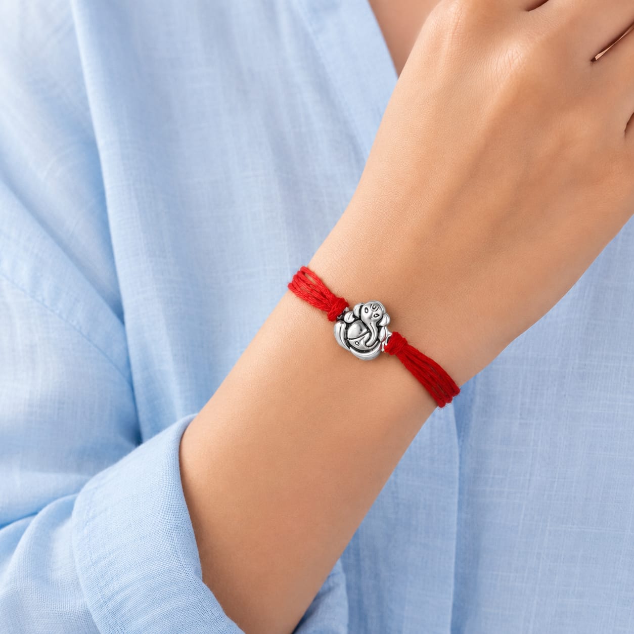 99.5% Pure Silver Ganesha Rakhi with Red Thread wear in hand for Brother by Madhaviya Jewels