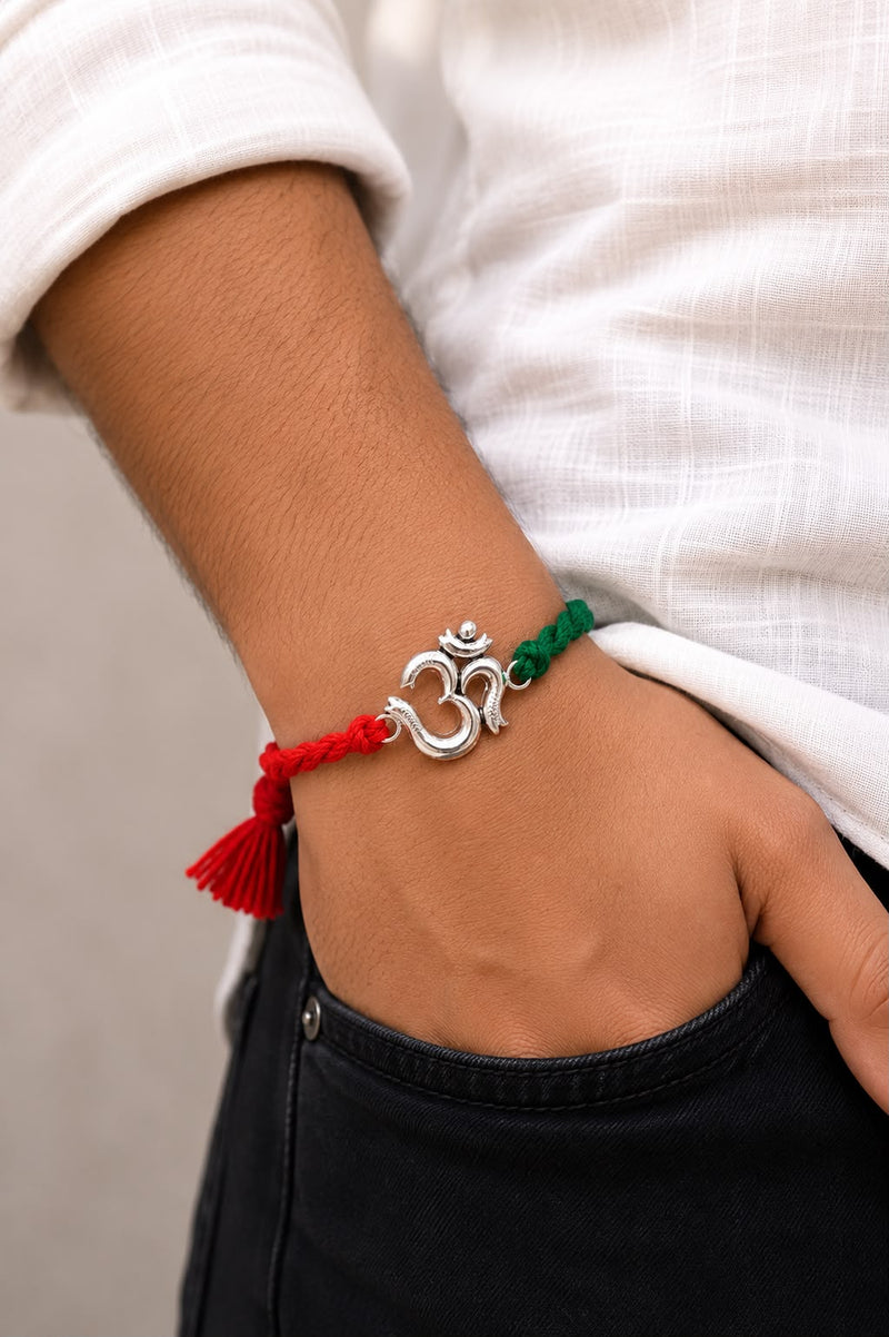 Silver Om Rakhi for Brother wear on hand with red and green braided thread | Premium Raksha Bandhan Rakhi by Madhaviya Jewels